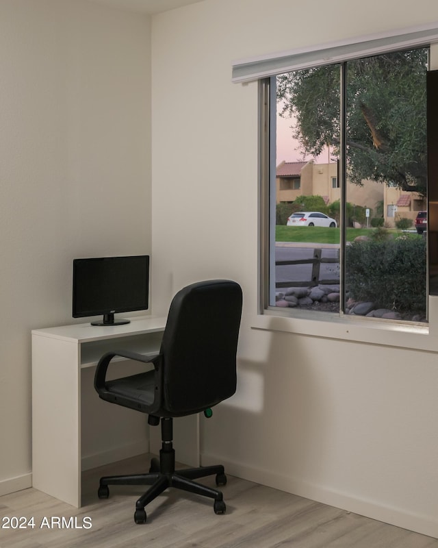 office space with wood finished floors and baseboards