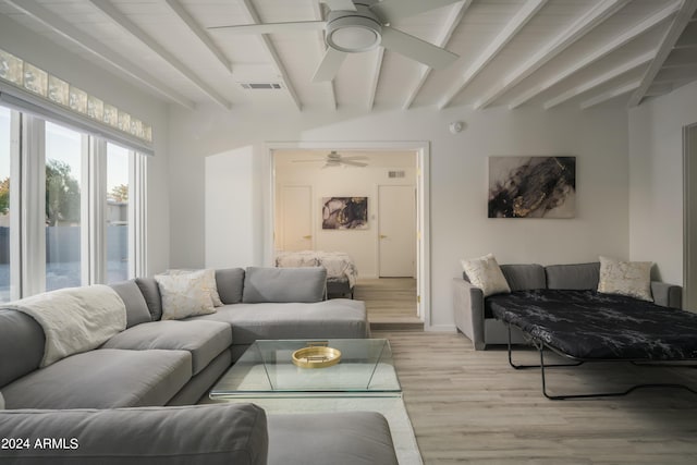 living room with light wood-style floors, a ceiling fan, visible vents, and beamed ceiling