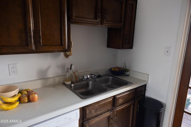 kitchen featuring a sink, dark brown cabinetry, light countertops, and dishwasher
