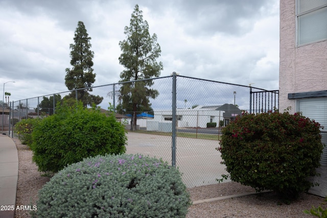 view of sport court featuring fence