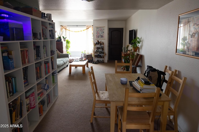 dining area with carpet flooring and a textured wall