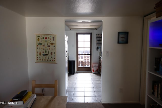 doorway to outside featuring light tile patterned floors