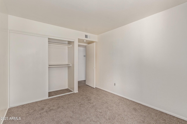 unfurnished bedroom featuring carpet floors and a closet