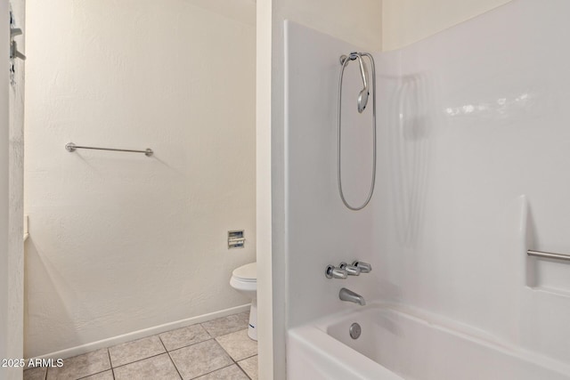 bathroom with tile patterned floors, bathing tub / shower combination, and toilet