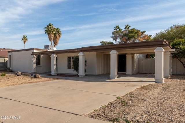 view of front of property featuring central AC unit and a carport