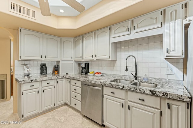 kitchen with sink, ceiling fan, backsplash, light stone countertops, and stainless steel dishwasher