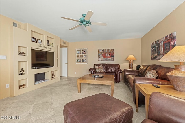 living room with built in features and ceiling fan