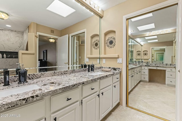 bathroom featuring vanity and a skylight