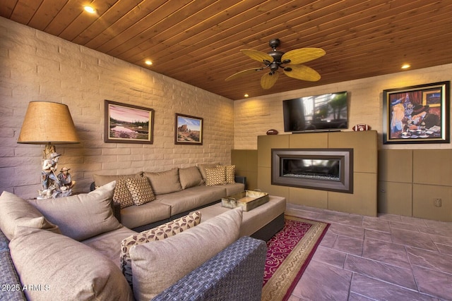 living room featuring ceiling fan and wooden ceiling