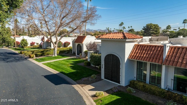 mediterranean / spanish-style home with a front lawn