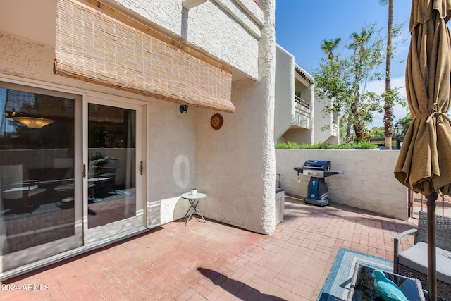 view of patio featuring a balcony and grilling area