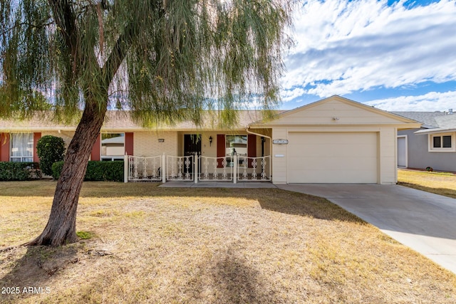 ranch-style home featuring a front lawn and a garage