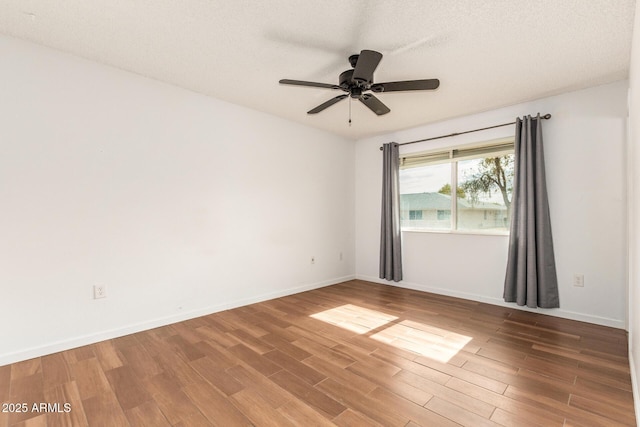 spare room featuring ceiling fan, a textured ceiling, and hardwood / wood-style floors