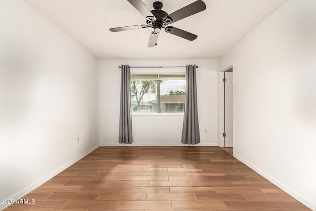 unfurnished room featuring a textured ceiling and ceiling fan