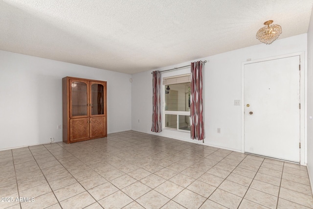 spare room with a textured ceiling