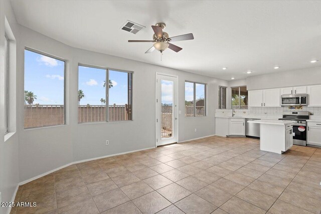 1453 E S Fork Dr, Phoenix, AZ 85048 - kitchen with stainless steel appliances, light countertops, ceiling fan, tasteful backsplash, and white cabinets