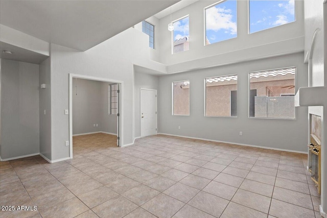 1453 E S Fork Dr, Phoenix, AZ 85048 - unfurnished living room featuring light tile patterned floors, a high ceiling, and baseboards