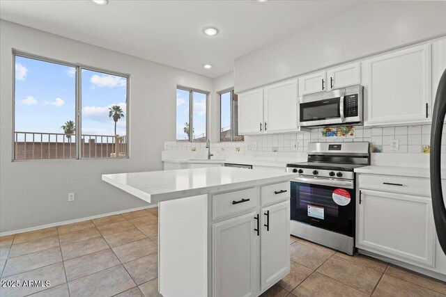 1453 E S Fork Dr, Phoenix, AZ 85048 - kitchen with stainless steel appliances, a sink, backsplash, light countertops, and white cabinetry
