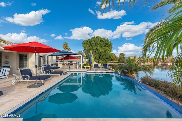 view of swimming pool featuring a water view and a patio area