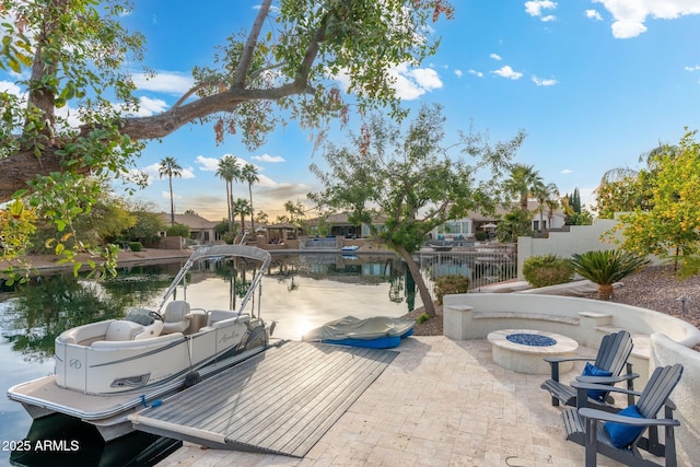 view of patio featuring a water view and an outdoor fire pit