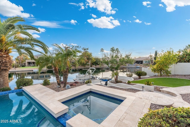 view of swimming pool with a patio area, an in ground hot tub, and a water view