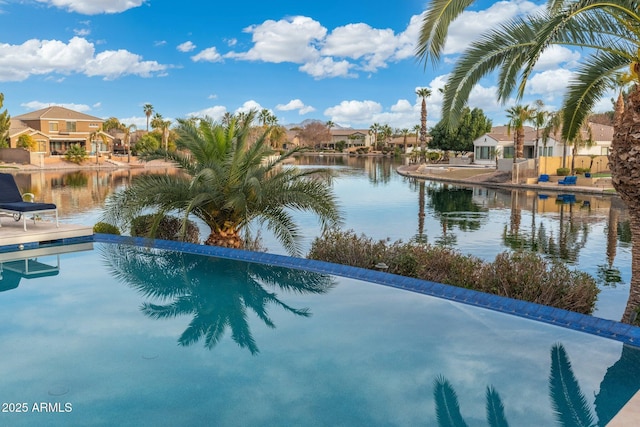 view of pool featuring a water view