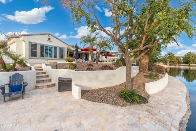 view of patio with a water view