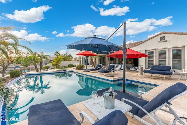 view of swimming pool featuring a hot tub and a patio