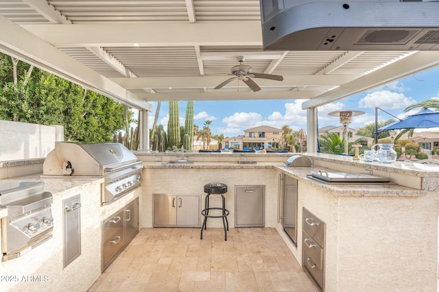 view of patio featuring ceiling fan, area for grilling, and a grill