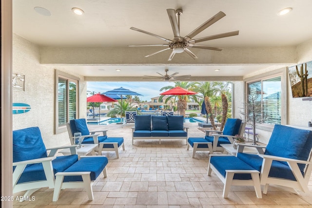 view of patio / terrace with a pool, an outdoor living space, and ceiling fan