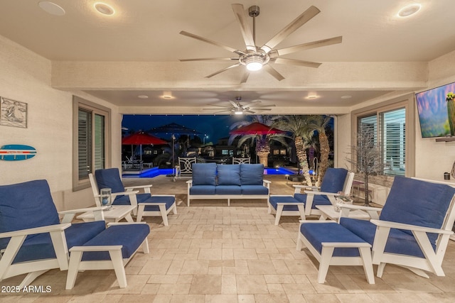 view of patio with ceiling fan and an outdoor living space