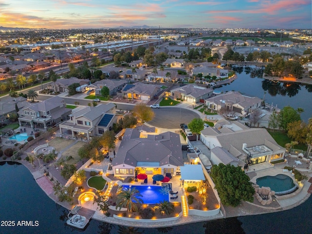 aerial view at dusk with a water view