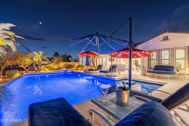 pool at night with a patio