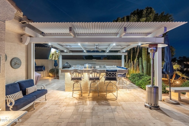 patio at night featuring an outdoor hangout area, a pergola, and an outdoor bar