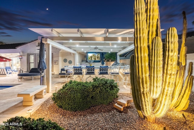 patio terrace at dusk featuring ceiling fan