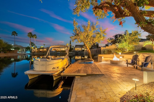 dock area featuring a fire pit, a patio area, and a water view