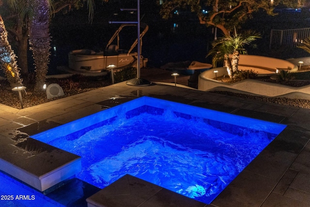 view of pool at night