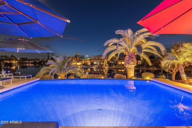 view of swimming pool featuring a water view