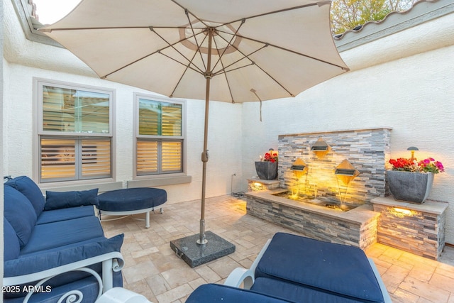 view of patio featuring an outdoor fireplace