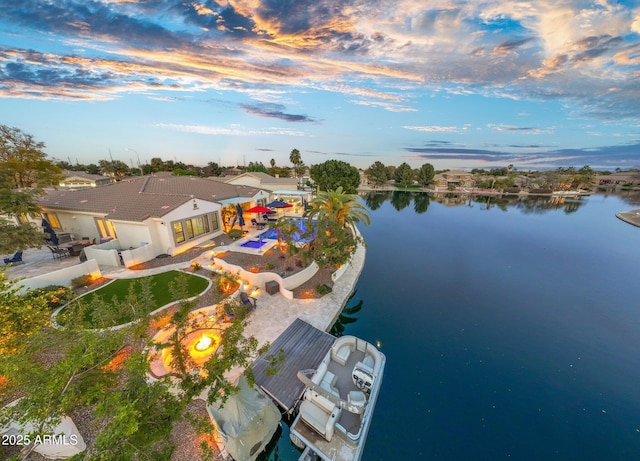 aerial view at dusk with a water view