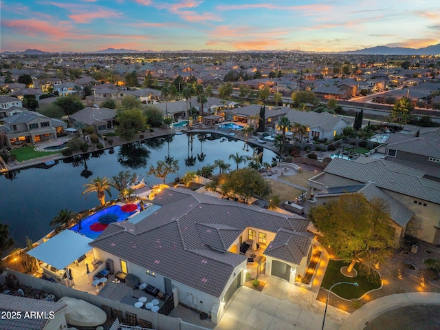 aerial view at dusk with a water view