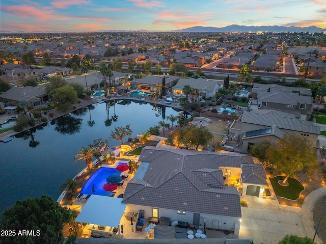 aerial view at dusk with a water view