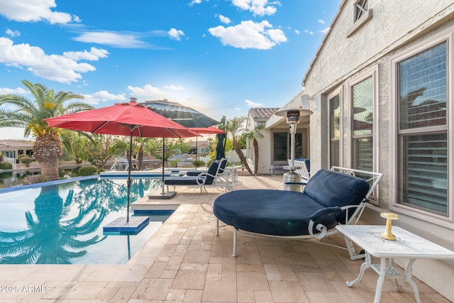 view of swimming pool featuring a patio area