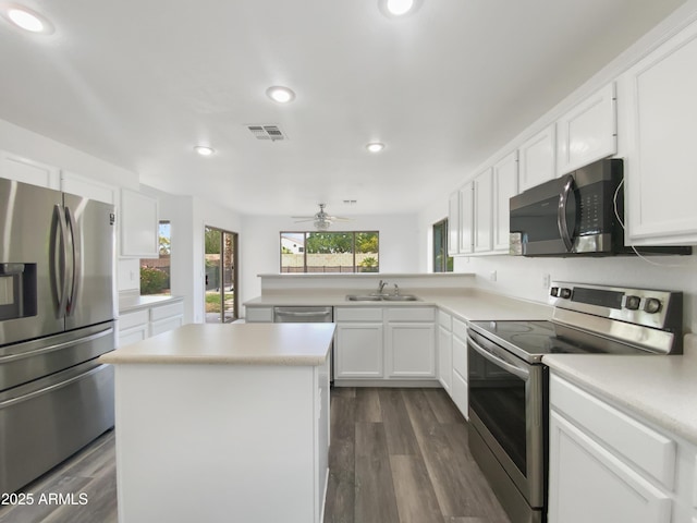 kitchen featuring visible vents, appliances with stainless steel finishes, white cabinets, and light countertops