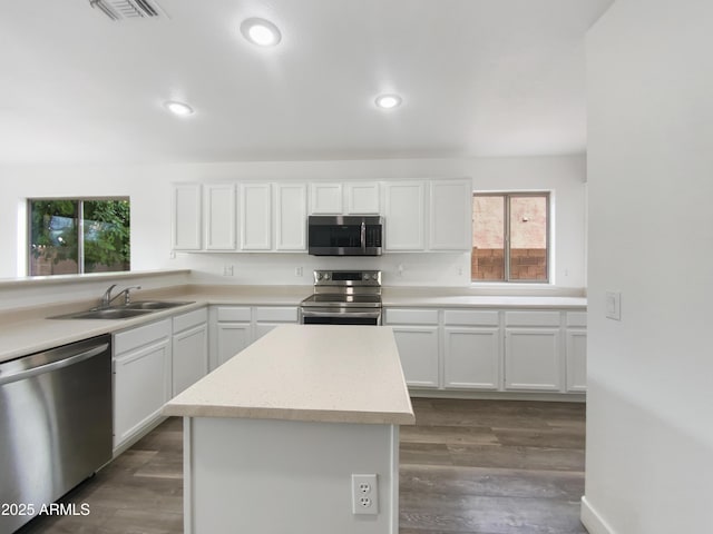 kitchen featuring visible vents, white cabinets, appliances with stainless steel finishes, and a sink