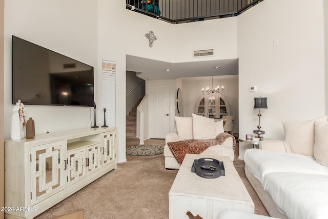 carpeted living room with a towering ceiling and an inviting chandelier