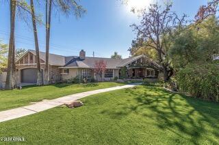 view of front facade with a front yard and a garage