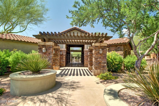 20750 N 87th St Unit 1065, Scottsdale, AZ 85255 - property entrance with stone siding, a tiled roof, a gate, a pergola, and stucco siding
