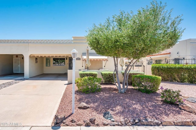 5209 N 78th St, Scottsdale, AZ 85250 - pueblo-style home featuring concrete driveway and stucco siding