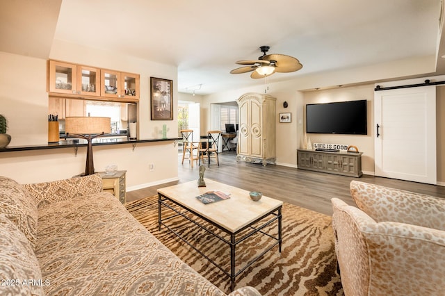 5209 N 78th St, Scottsdale, AZ 85250 - living room featuring ceiling fan, wood finished floors, baseboards, and a barn door